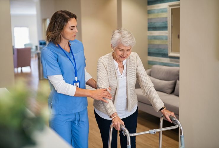 Enfermeira exercendo cuidado domiciliar na casa de uma idosa após contratada