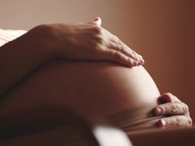 Mulher grávida acariciando sua barriga