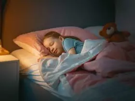 criança está dormindo na cama Por choreograph